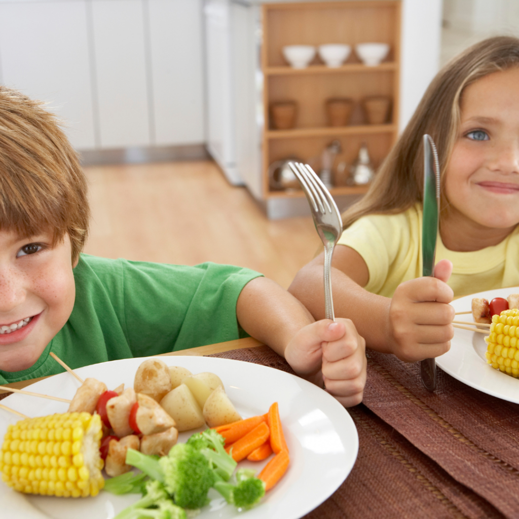 a boy and girl with plates of food